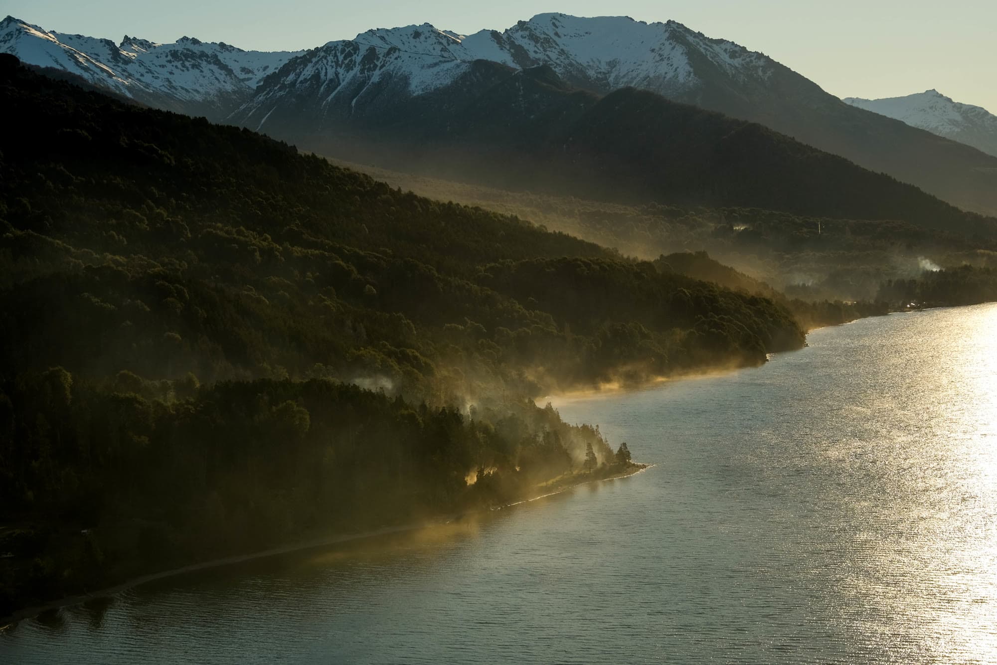 Misty mountain lake at golden hour